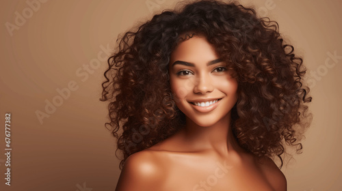Curly girl with clean healthy skin. Beige background. 