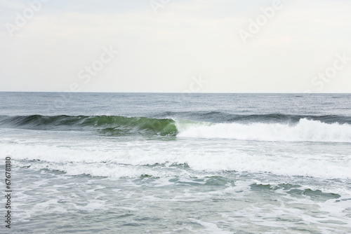 beach waves  a soothing symphony of nature s power and serenity  crashing on a sandy shore under a clear blue sky