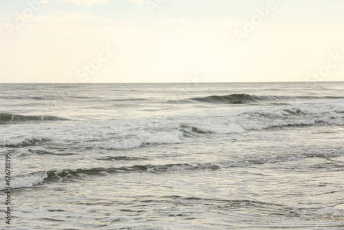 beach waves, a soothing symphony of nature's power and serenity, crashing on a sandy shore under a clear blue sky
