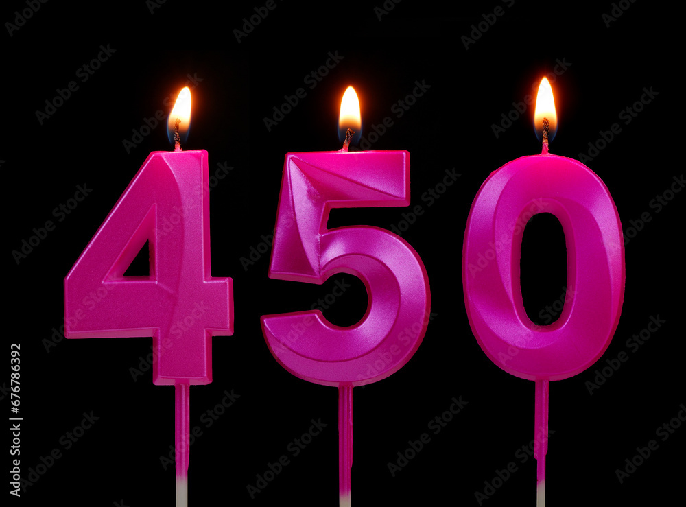 Burning pink birthday candles isolated on black background. Number 450. Burning pink birthday candles isolated on black background. Number 450.