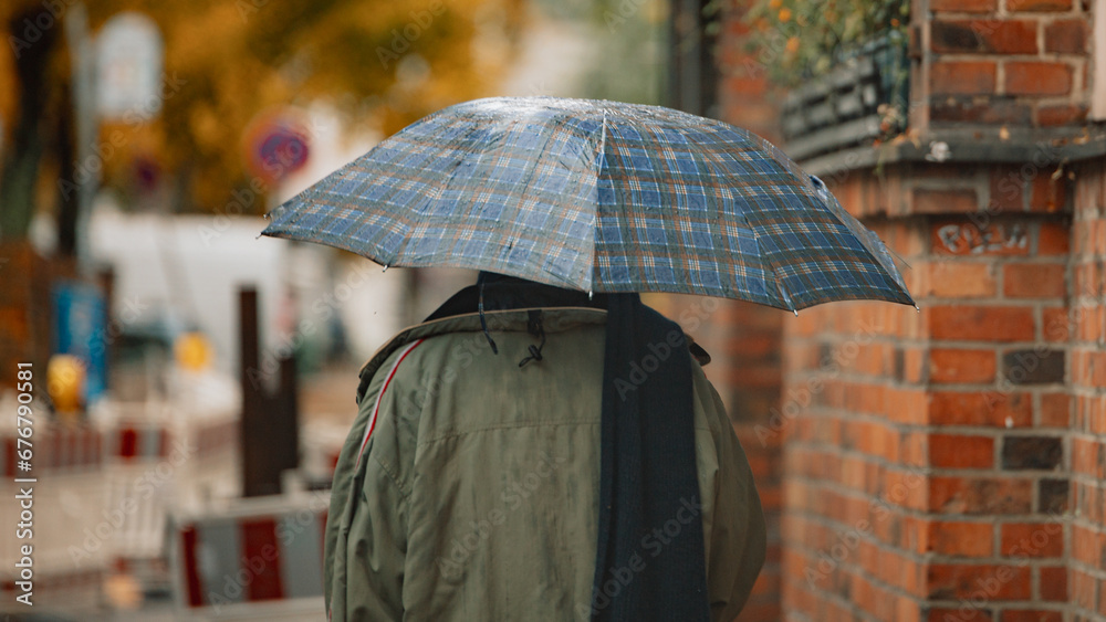City Rain: Person with Umbrella in Wet Weather