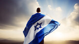 man with israel flag over bright sky background