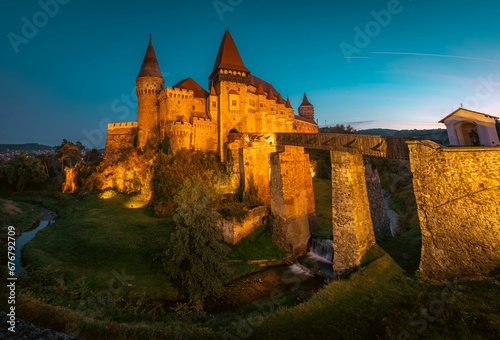 Castle with a clock tower in the background: Corvin Castle Hunedoara Romania