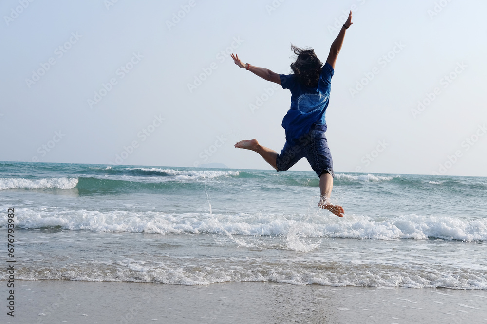 Happiness of Asian woman is jumping on sky with sea and wave on the sand beach in natural sunset. Freedom lonely life on vacation Happiness of Asian woman is jumping on sky with sea and wave on the sand beach in natural sunset. Freedom lonely life on vacation