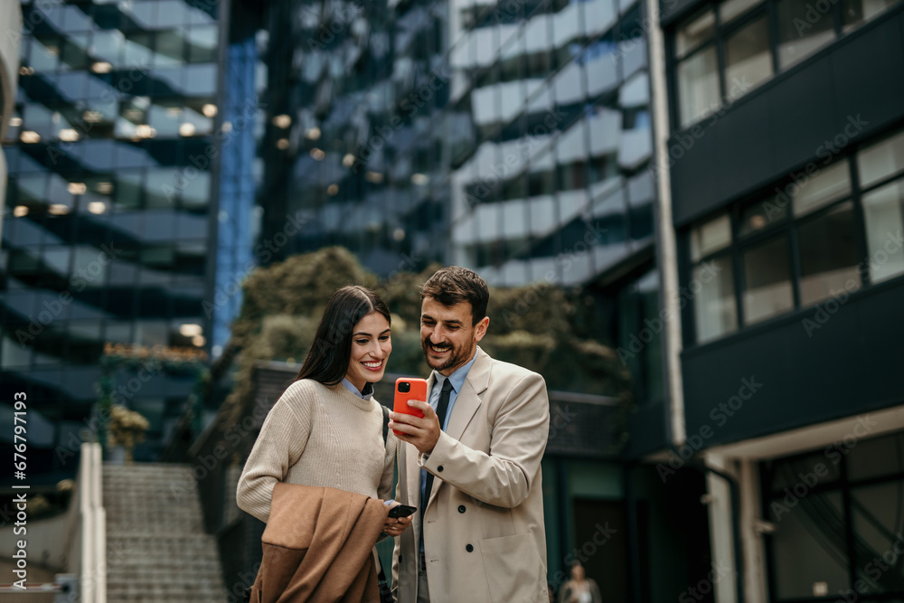 Fototapeta premium A couple of business persons talking outside of office building