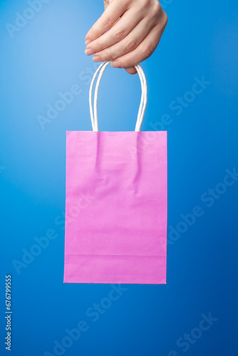 pink shopping bag in hand, gift bags, online shopping