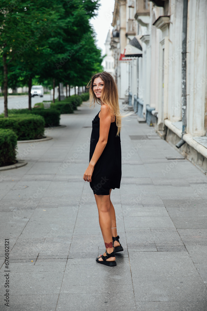 woman in black dress on the street walk travel vacation