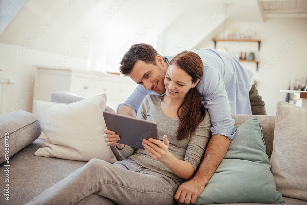 Young couple using tablet together at home