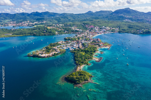 Peninsula and marina in Caribbean blue Martinique's coast with yachts and hills photo