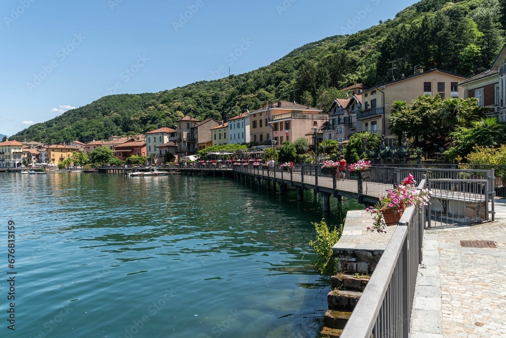 Houses along the river with beautiful water and some plants in flower pots in Italy Houses along the river with beautiful water and some plants in flower pots in Italy