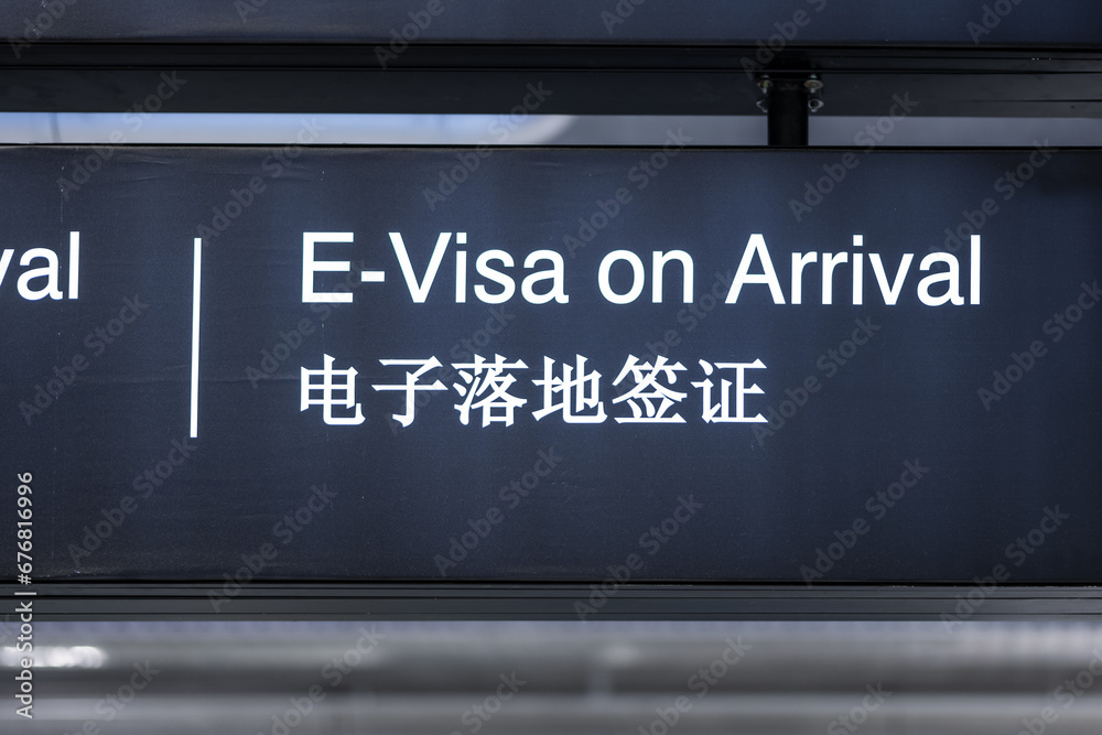 Electronic Visa on arrival signage concept at airport for tourists. Visa sign in English and Chinese in airport Electronic Visa on arrival signage concept at airport for tourists. Visa sign in English and Chinese in airport