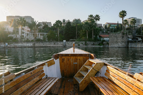 Fotografiet The prow of the boat faces the view of the old city of Tiberias on the Sea of ​​