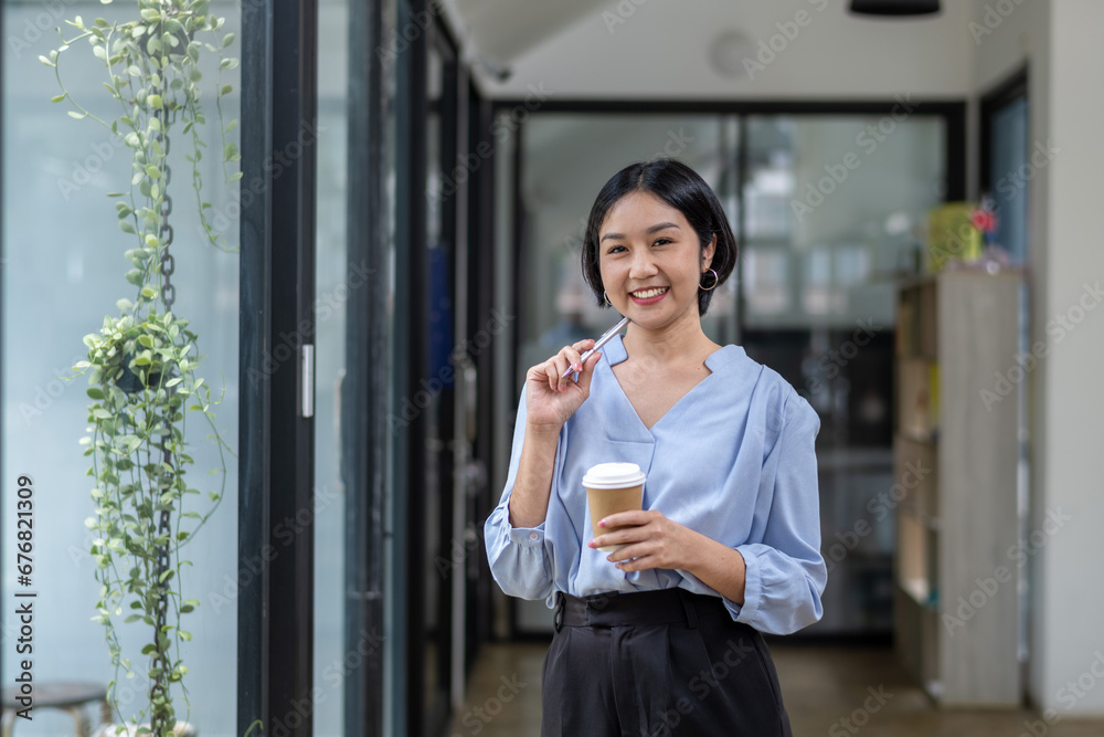 Business woman still thinking about work in a good mood during coffee break.