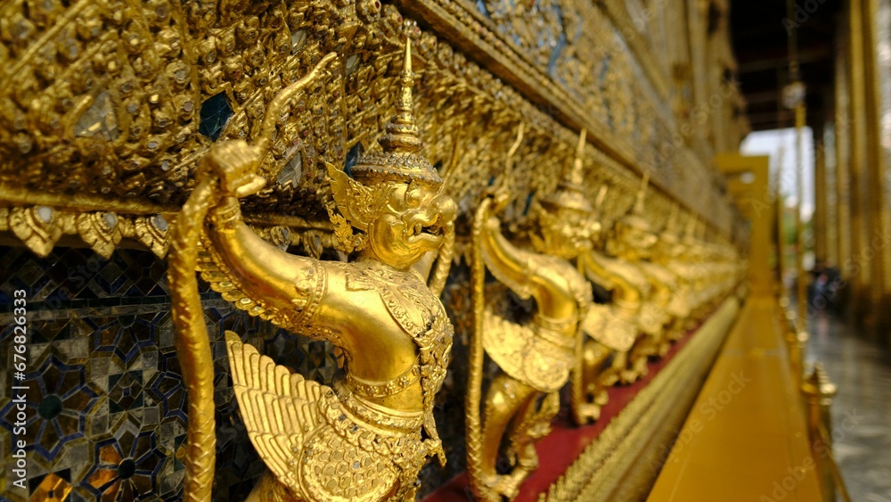 Selective focus shot of golden garuda statues inside 
Temple of the Emerald Buddha in Thailand