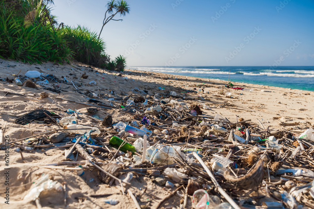 Beach and plastic trash in Bali island. Pollution by plastic rubbish on ocean coastline