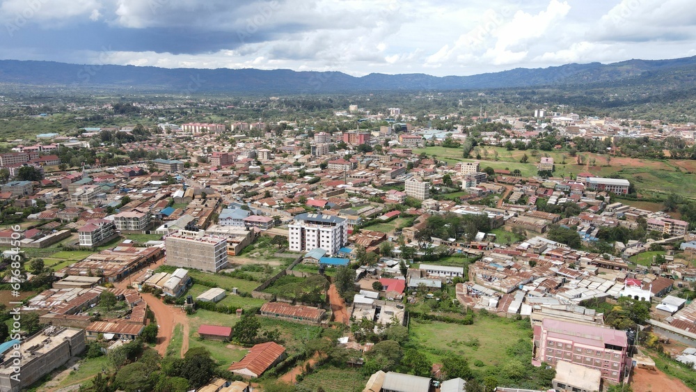Aerial view of the cityscape with a cloudy sky in the background