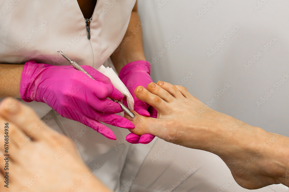 Woman legs In a Spa Salon Receiving Classical Pedicure, cutting of
