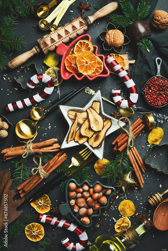 Fototapeta Naklejka Na Ścianę i Meble -  Christmas card. background with Christmas winter spices and ingredients for baking on a dark slate.