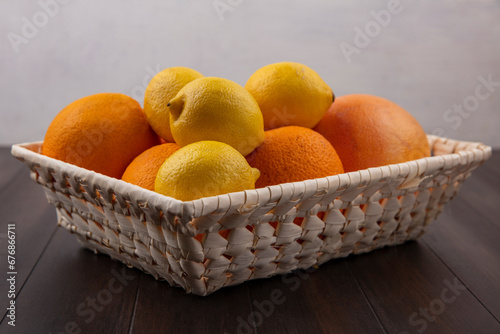 front view fresh sliced orange and lemon on dark background ripe mellow fruit juice color citrus tree citrus, Whole and sliced ripe oranges placed on marble background, half orange and lemon fruit.