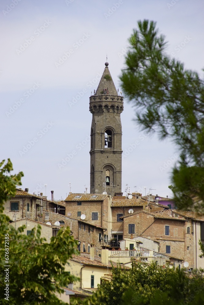 Vertical shot of the ancient bell tower in the historic center of Peccioli, Italy