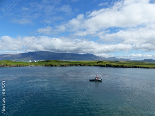 Landscape scene of coastline on green beach by the sea in Reykjavik, Iceland