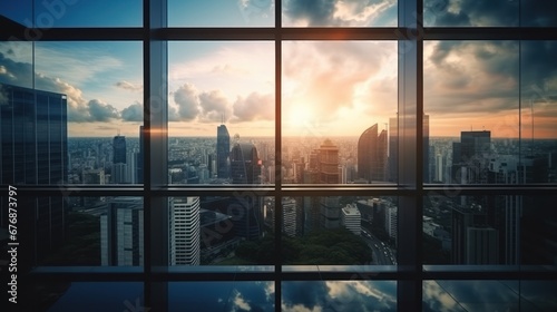 Sunrise or sunset with the city,View through glass windows for take aerial view of buildings in the city