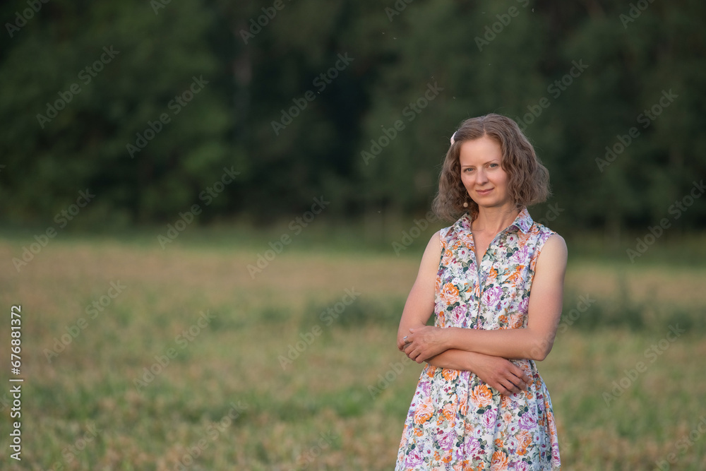 Portrait of a young beautiful girl in a light dress on a summer field. Portrait of a young beautiful girl in a light dress on a summer field.