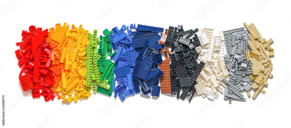 Naklejka premium Lot of colorful rainbow toy bricks background on white. Educational toy for children. Novosibirsk, Russia - October 26, 2023.