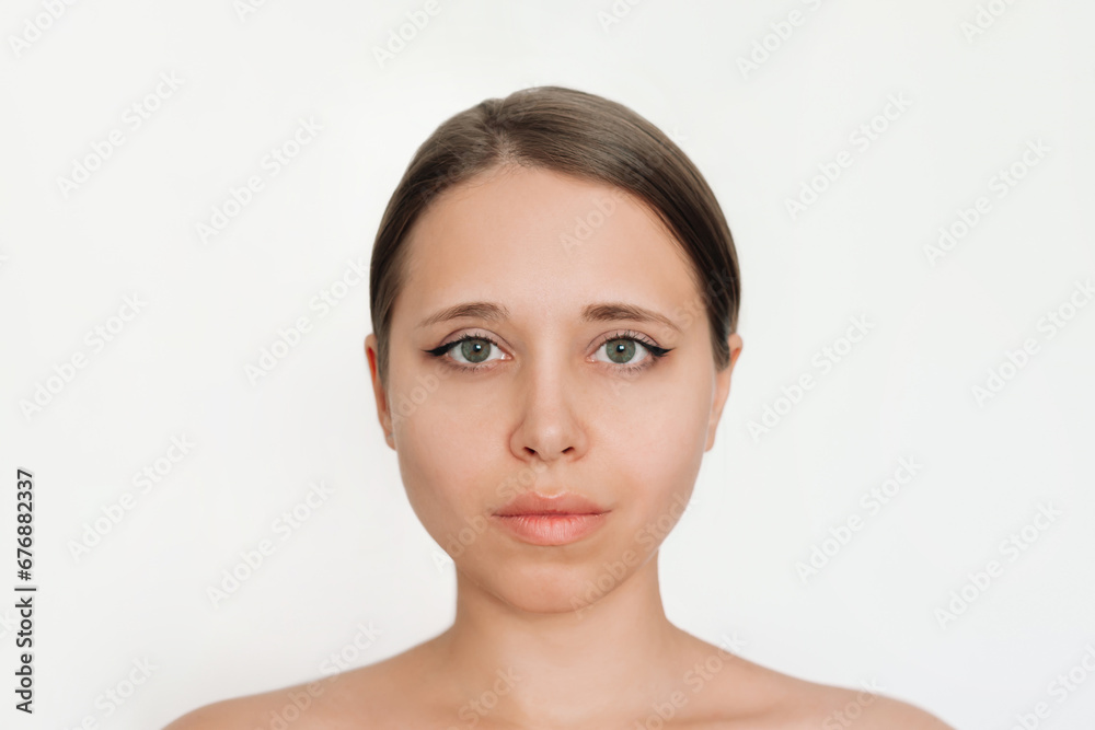 Portrait of a young attractive caucasian blonde woman with makeup isolated on a light background. Natural beauty and fashion. Skin care Portrait of a young attractive caucasian blonde woman with makeup isolated on a light background. Natural beauty and fashion. Skin care