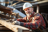 A man working on a wooden piece of construction.