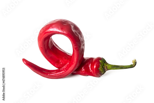 Bright red, twisted spiral, burning chili pepper on a white background