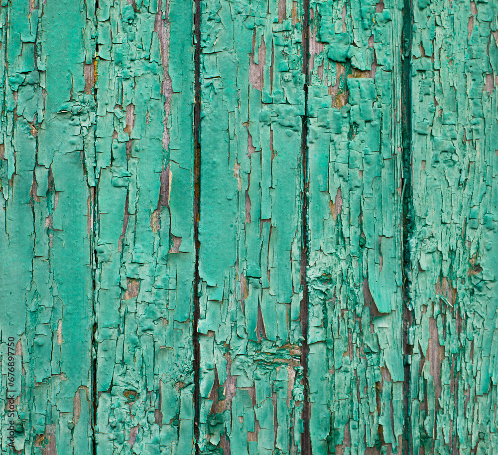 Wooden surface with cracked green paint