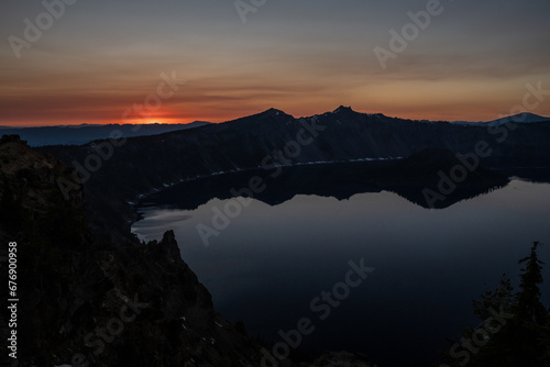 Dark Shadows Of Surrounding Cliffs Reflect In Crater Lake