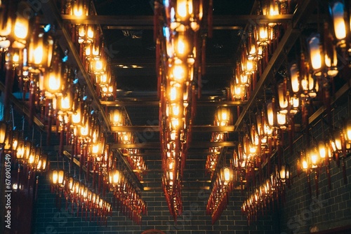 Closeup shot of beautiful lanterns hanging in a temple © Wirestock