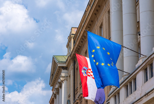 Flags of Croatia and European Union on Croatian Parliament building in Zagreb. Concept of Croatia becoming a member of Schengen and European Union