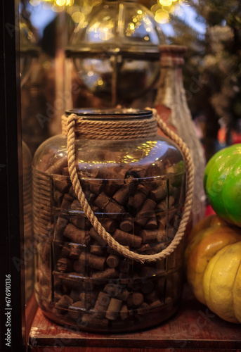 decorations in a cafe made of wine corks in a big bottle and pumpkins