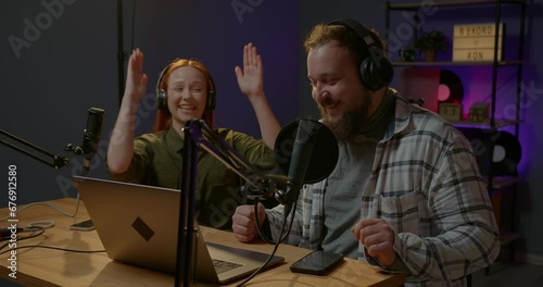 Man having conversation with woman in internet broadcast using professional microphone and audio mixer. Online radio station host recording podcast interviewing guest in late night talk show.