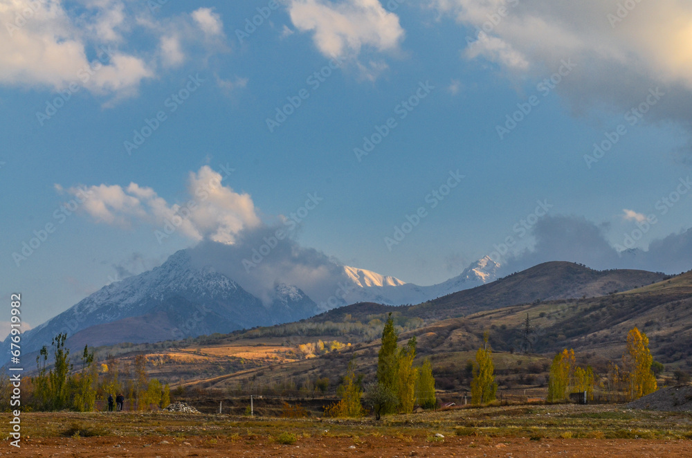 scenic view of snow covered peaks of Chatkal ridge from Charvak reservoir (Yusufhona, Tashkent region, Uzbekistan)