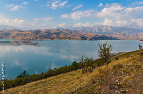 scenic view of Charvak reservoir and Tian Shan mountains in late autumn (Yusufhona, Tashkent region, Uzbekistan) photo