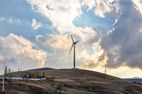 windmill on the hills near Charvak lake in Tian Shan mountains (Yusufhona, Uzbekistan)