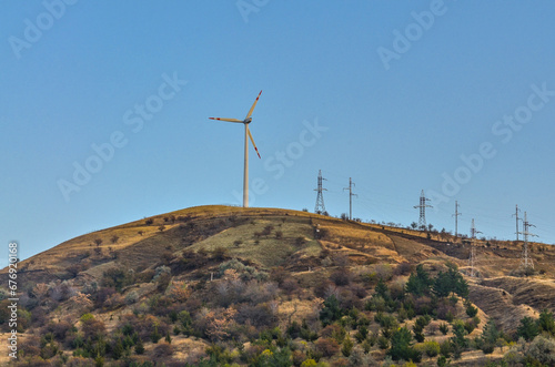 windmill on the hills near Charvak lake in Tian Shan mountains (Yusufhona, Uzbekistan)