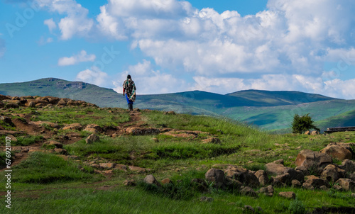 Foto Basotho man with basotho blanket and basotho hat walking in the mountains in Sem