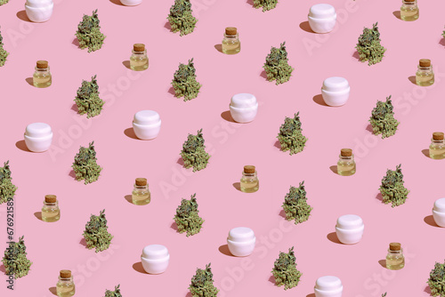 Cosmetic pattern from bottles of cannabis oil and cream on pastel background