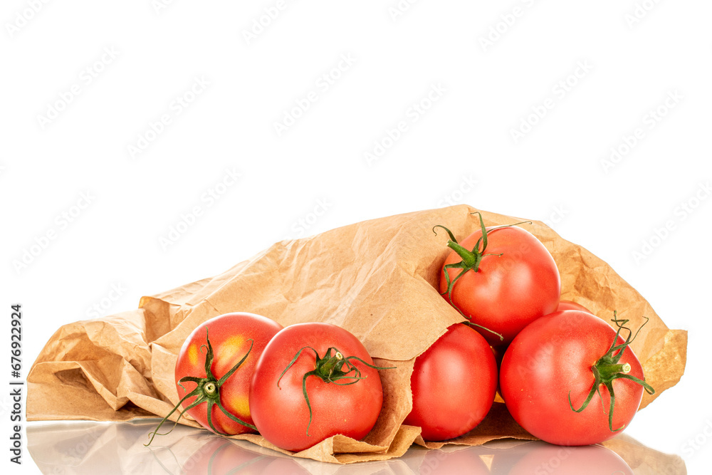 Several pink juicy tomatoes with paper bag, macro, isolated on white background.