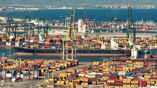 Aerial view of Cargo container transport ship and crane at Valencia, Spain. sea port industrial district. Logistic industry, transportation business concept. photo