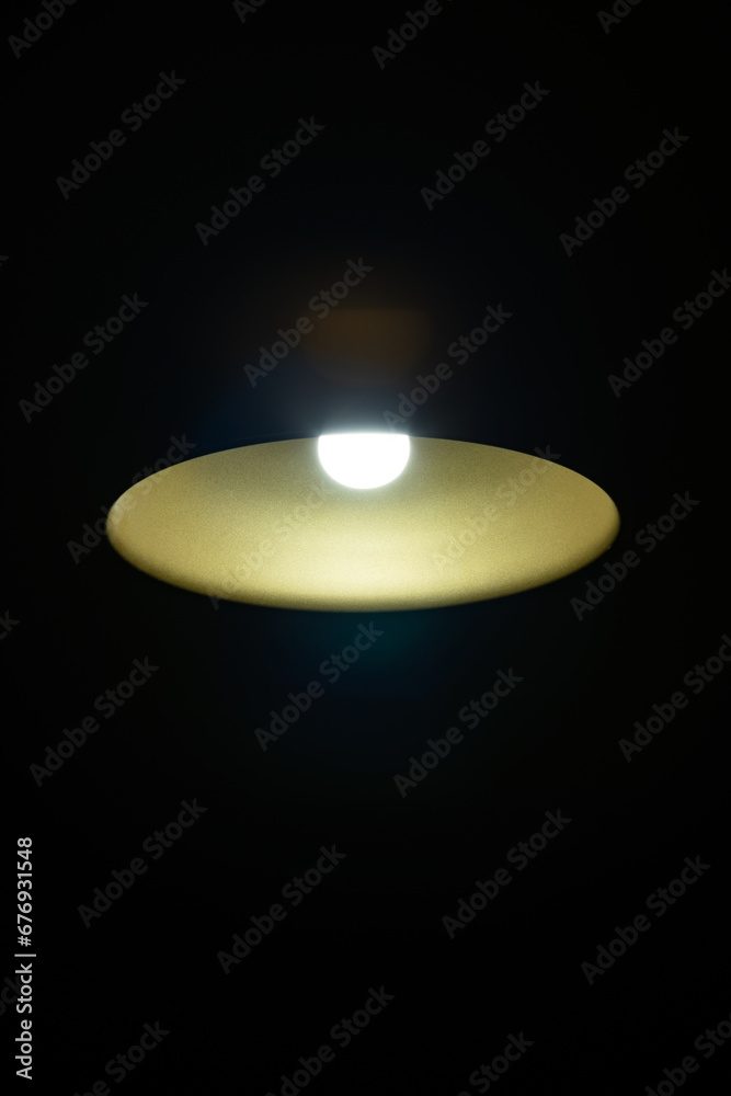 LED lamp in the ceiling on a dark background in the center of the frame, bottom view.