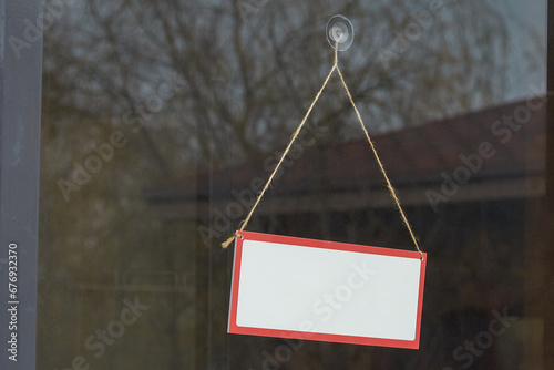 A sign on a rope glued to the window with a suction cup, a place for the inscription