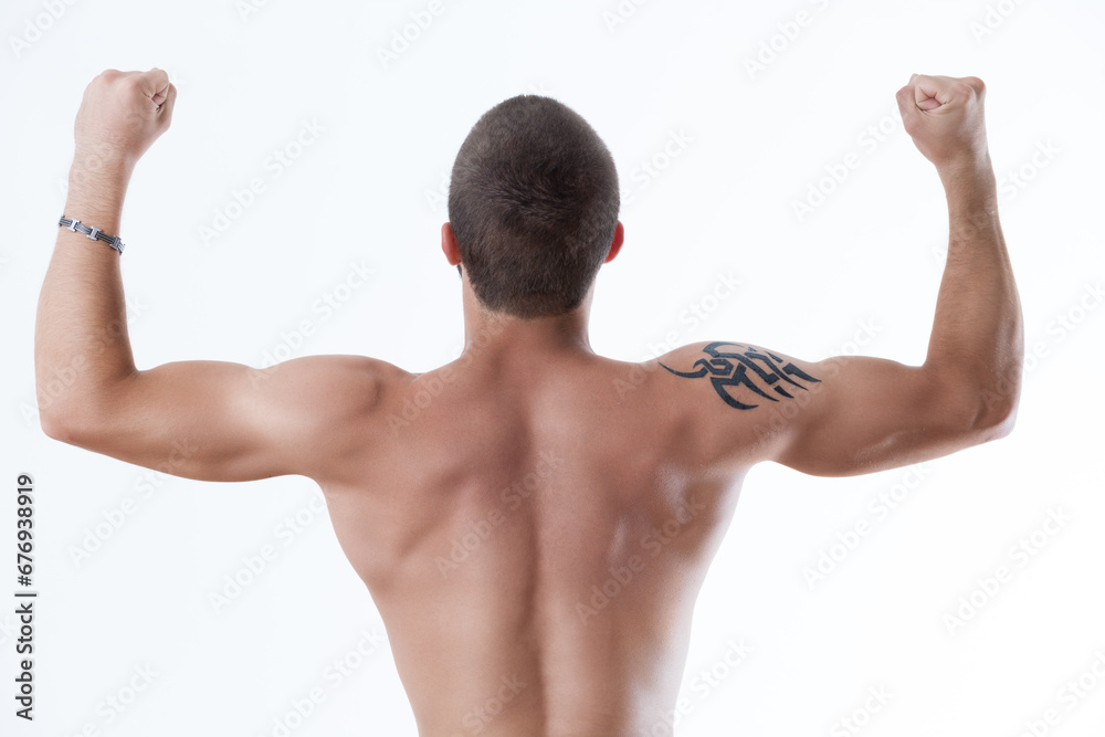 Victory pose, muscular back, tribal tattoo Victory pose, muscular back, tribal tattoo
