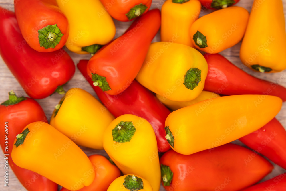 delicious and healthy red, orange and yellow sweet peppers on a wooden cooking board ready to be prepared in one recipe delicious and healthy red, orange and yellow sweet peppers on a wooden cooking board ready to be prepared in one recipe