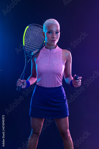 Squash player on a squash court with racket. White sportswear. Beautiful girl teenager and athlete with racket on court. Sport concept. © Mike Orlov